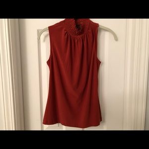 Rust-colored, sleeveless blouse